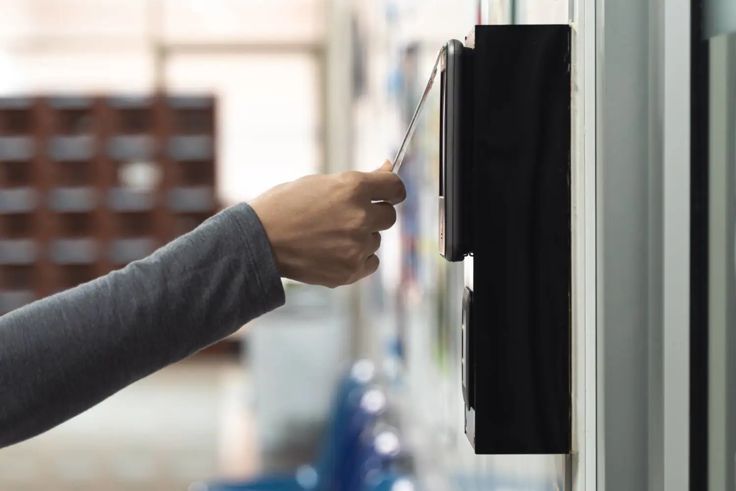 A hand using key card on scanner (417637482)_Medium.jpeg